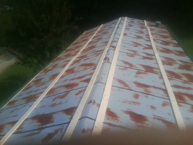 Rusted metal roof panels with new wood purlins before replacement — Storm Damage Roof Repair in Mifflintown by Roofing Brothers