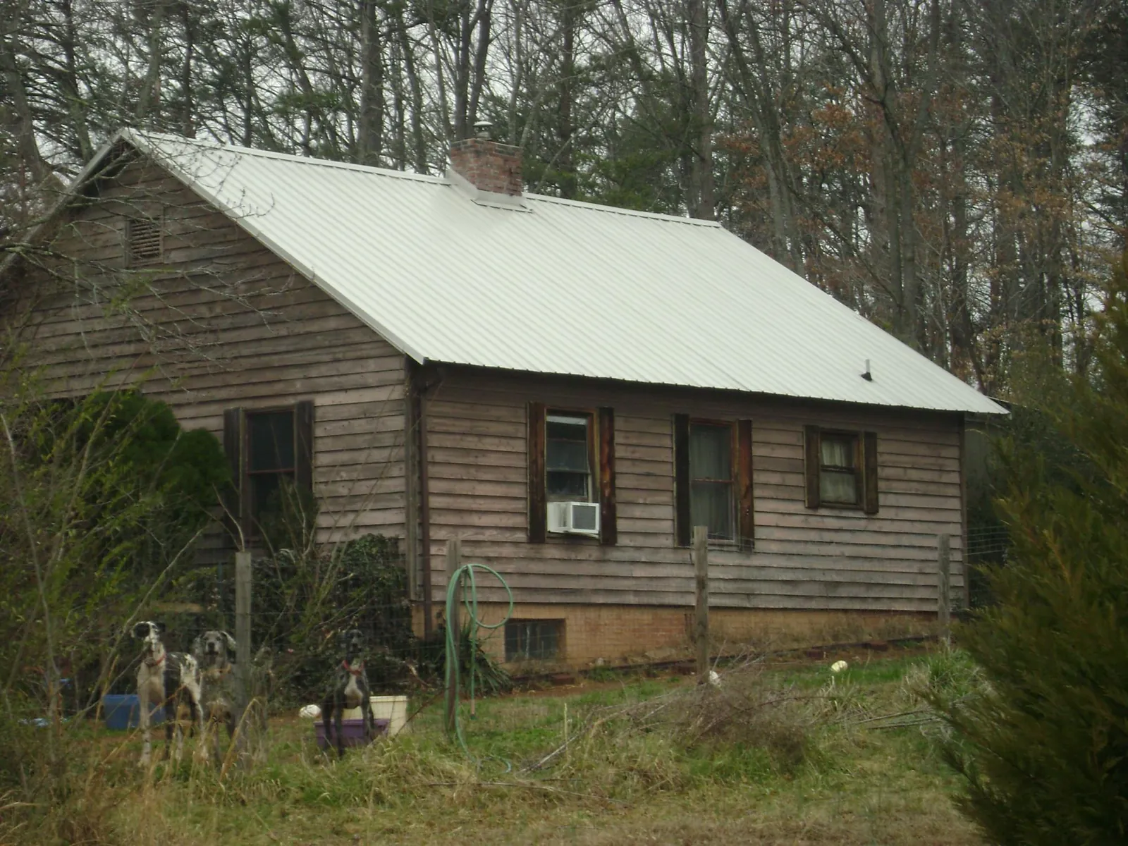 White metal roof on an old wood sided farmhouse, from a Metal Roof Installation job in Mifflintown